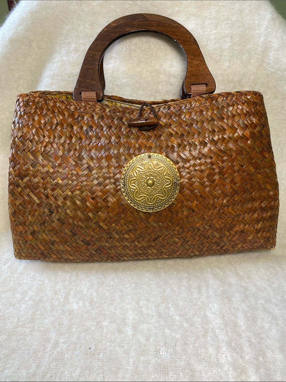 Brown Woven Straw Tote Handbag with Decorative Gold Medallion